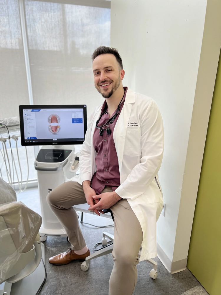 Dr. Macaelan Hanrahan in the treatment room, with an intraoral scan on screen